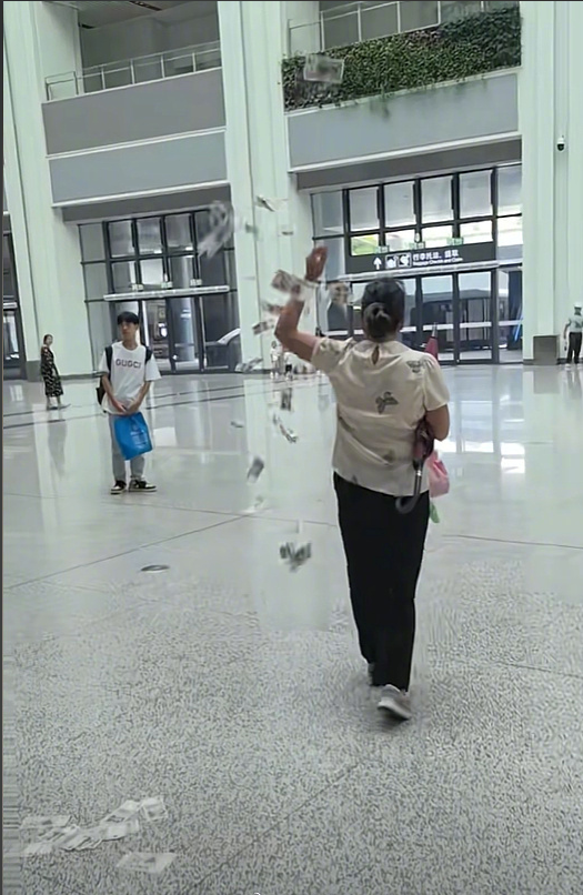 女子高铁站边走边撒纸币 撒了好几轮都被人捡走 背后原因成谜